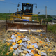 Image for article titled Photos: Russian officials use a 45-ton bulldozer to flatten illegal Western cheeses